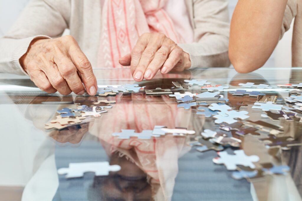 A senior citizen works on a puzzle at home as a support for their cognitive decline from dementia and Alzheimers in St. Pete Florida.